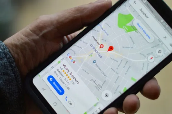 Smartphone con Google Maps activo mostrando ruta predictiva en una ciudad con tráfico