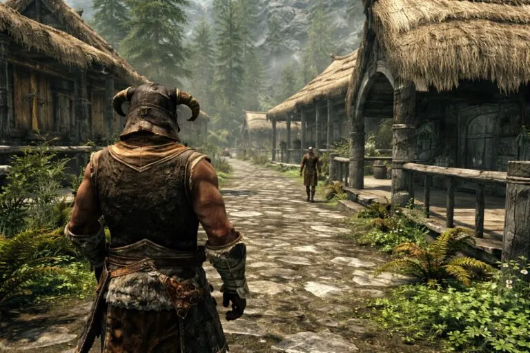 Vista en tercera persona de Skyrim, con el protagonista caminando por un poblado nórdico, rodeado de casas rústicas y vegetación