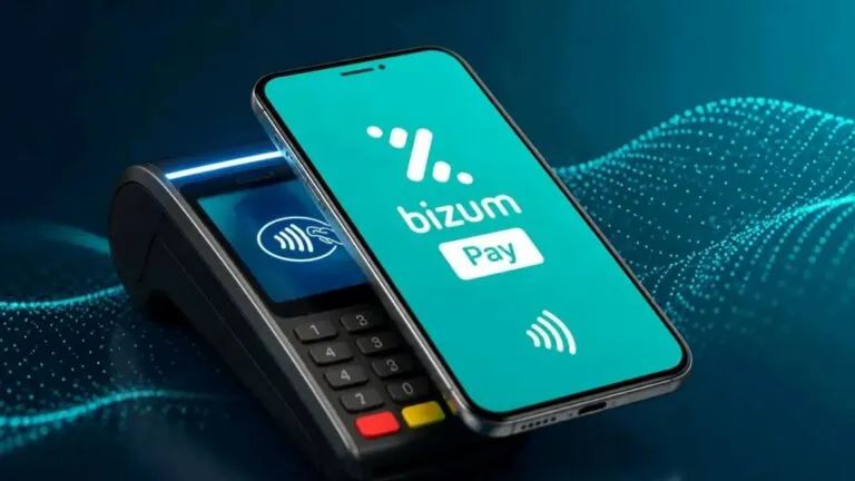 Celular acercándose a un terminal de pago para representar las compras presenciales mediante Bizum Pay.